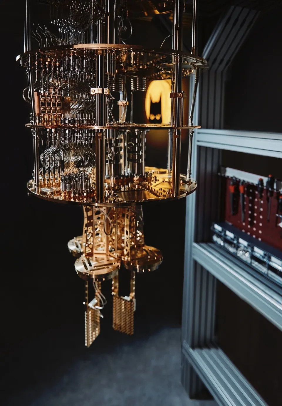 A cryostat in Alice & Bob's Paris lab: the cat-qubit chips sit at its cold bottom, fed by the coaxial lines running down the stages