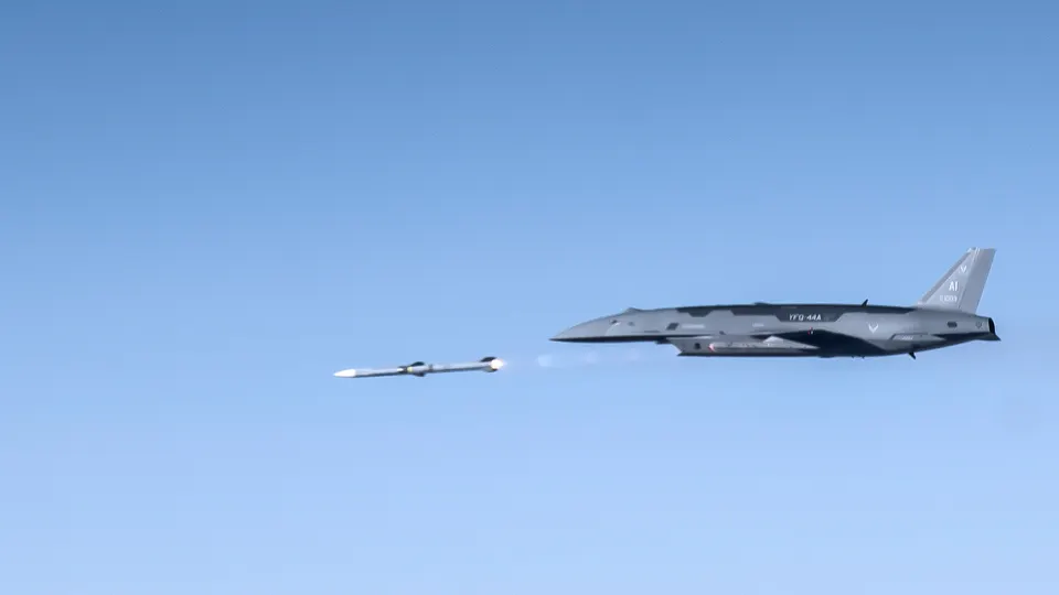 A pilotless YFQ-44A Fury firing an air-to-air missile over the Mojave in 2026: the uncrewed wingman carries weapons for the crewed jets it flies with