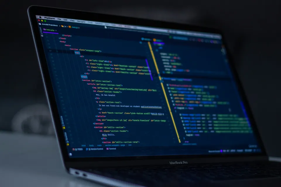 A code editor on a laptop: Cursor is a modified VS Code that predicts the next edit and runs an agent inside this kind of editor window