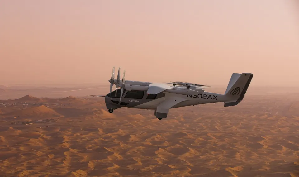 Midnight in wing-borne flight over the UAE desert: the front propellers have tilted forward to pull, the rear lift rotors are stopped