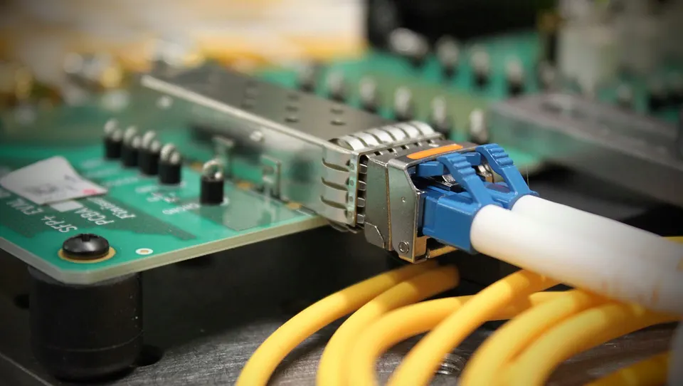 Fibres plugged into a pluggable optical transceiver at a board's edge: the conversion TeraPHY moves into the chip package itself