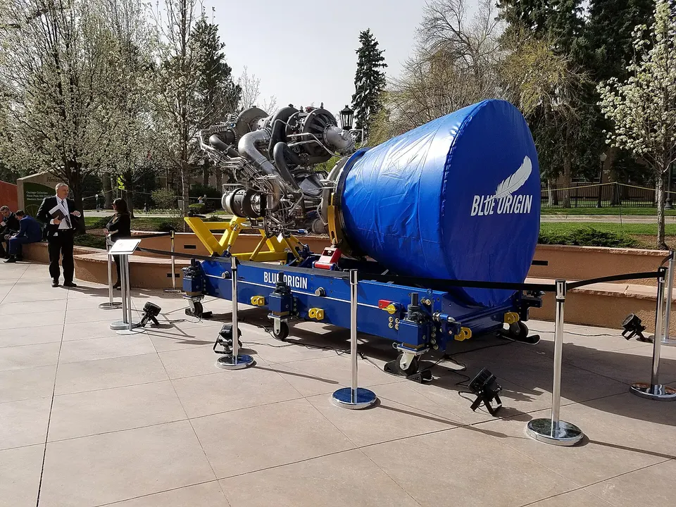 A BE-4, the methane engine New Glenn's booster uses seven of; the blue cover hides the nozzle, the pumps and pipes sit behind