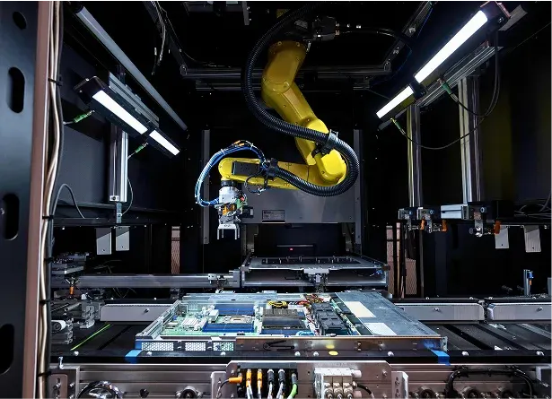 Inside a Bright Machines robot cell: a camera-guided arm works over a server board, the kind of GPU-installation job the cells are programmed for