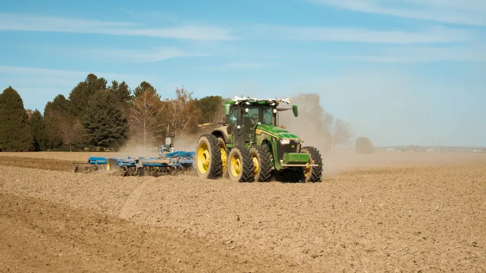 A tractor with the Carbon kit preparing ground on its own: roof cameras and sensors steer it while staff watch remotely