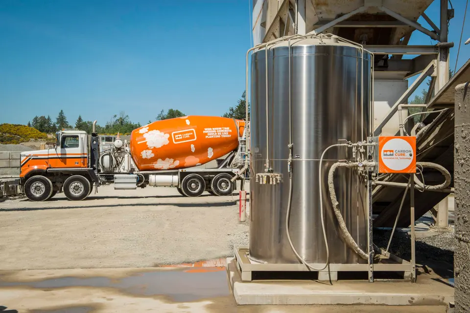 A CarbonCure CO2 tank and valve box at a concrete plant: it doses measured CO2 into each batch as the mixer is loaded