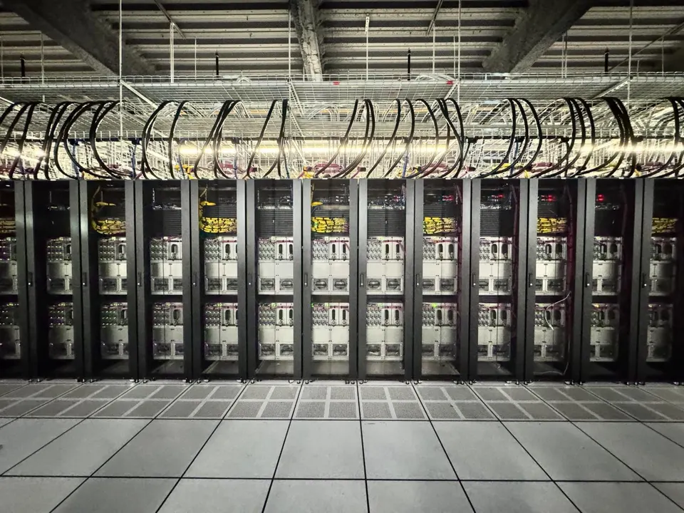 A Cerebras wafer-scale cluster: rows of Cerebras systems, each built around a single wafer-sized chip, fed by the cabling overhead
