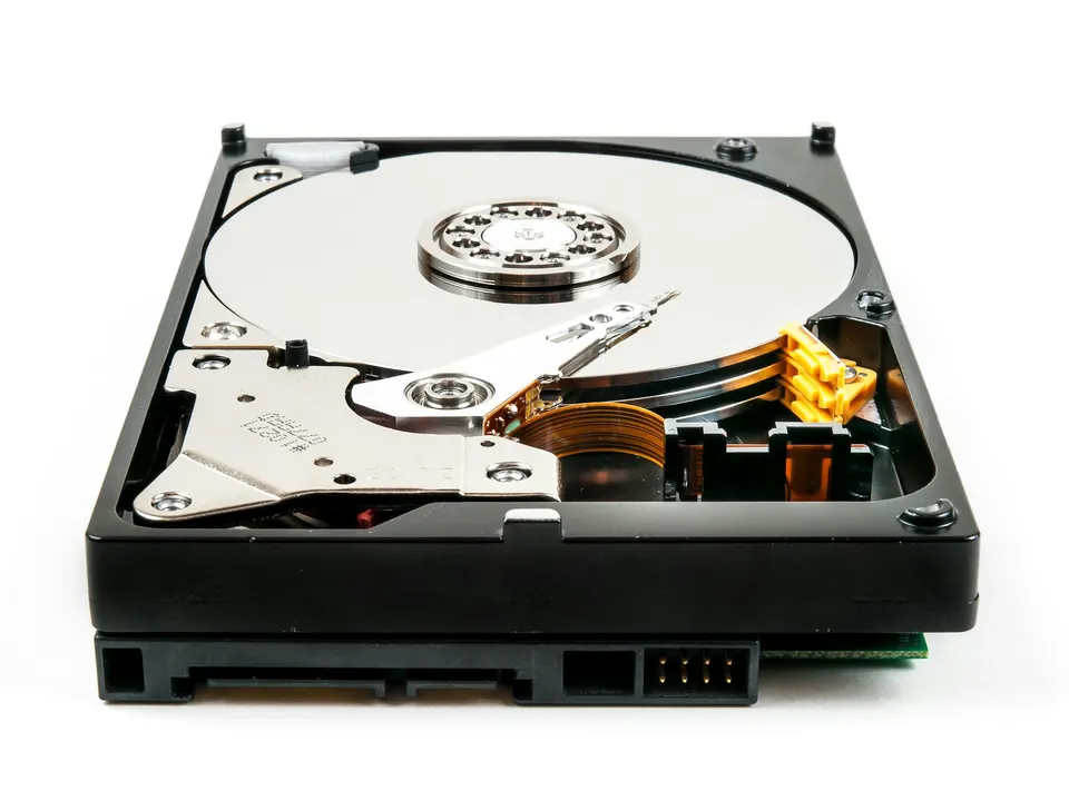 An opened hard drive: EigenDA cuts rollup data into coded pieces and spreads them across many operators' storage