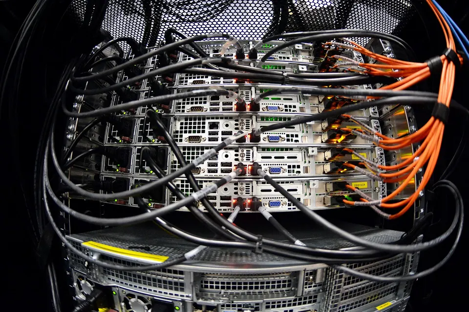 A rack of cabled servers: EigenLayer operators run services on machines like these, backed by restaked ETH they lose if they cheat