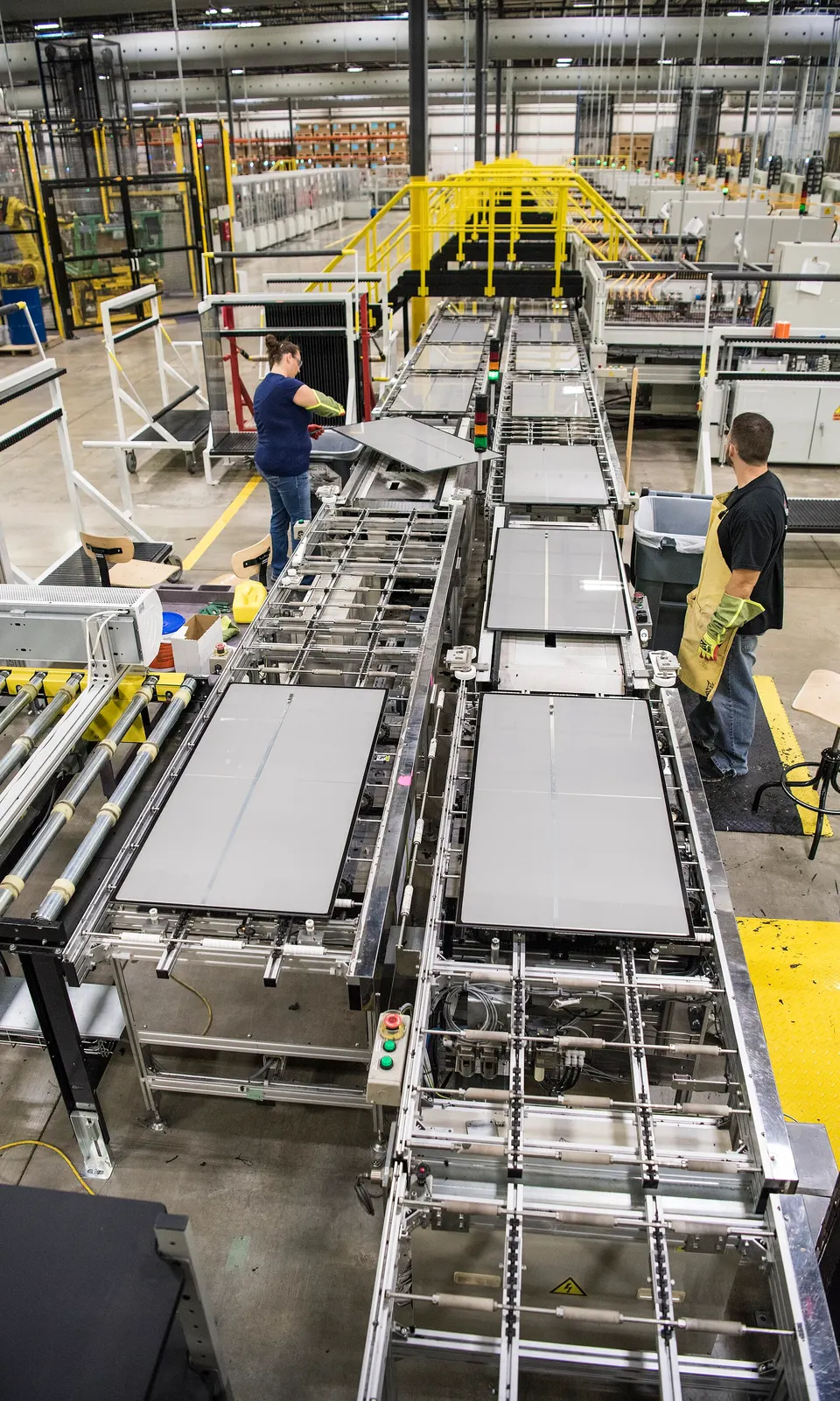 First Solar's Perrysburg, Ohio line in 2017, making the earlier Series 4 panels: plain glass goes in and finished CdTe panels come out hours later