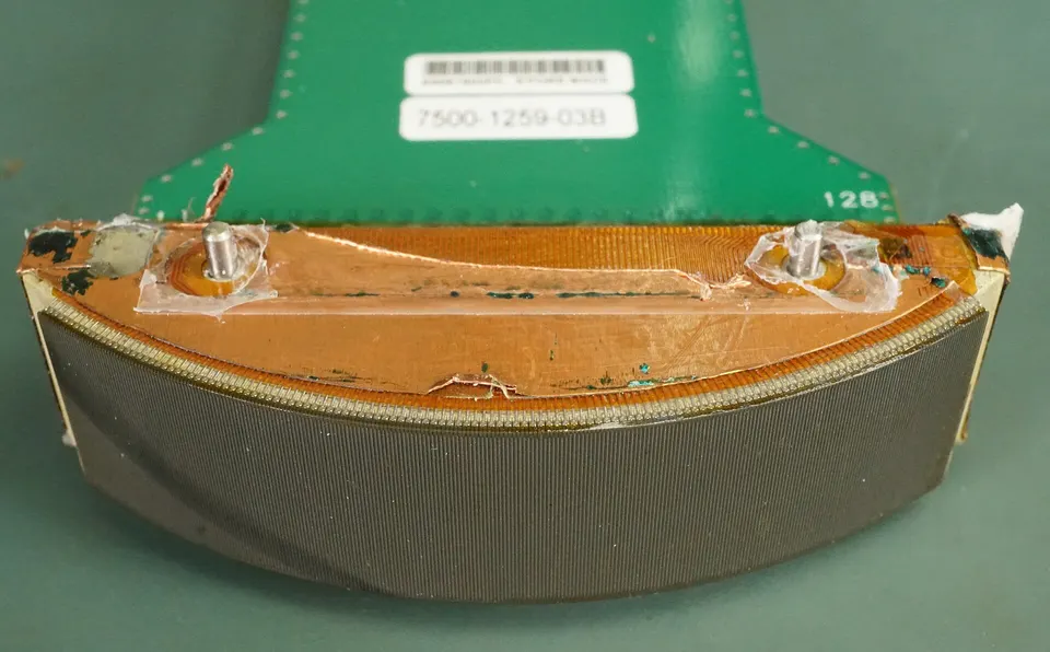 Inside an ultrasound probe: a curved row of 128 tiny transducers that send and time sound pulses, the building block of ultrasound brain imaging