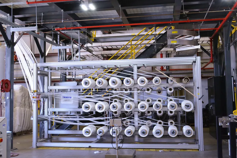Spools of acrylic precursor thread at the start of Oak Ridge's carbon-fibre line; baked in stages, it becomes carbon fibre, as HexTow does