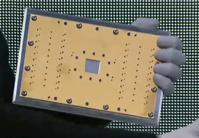 An earlier IBM quantum processor in its gold-plated mount (2023), not Nighthawk: the small square chip in the middle holds the qubits