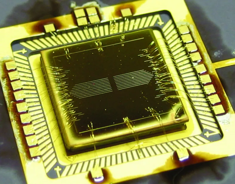 A packaged surface ion trap from Oxford, not IonQ's: ions hover above the chip's electrodes, the approach IonQ is moving onto standard-made chips