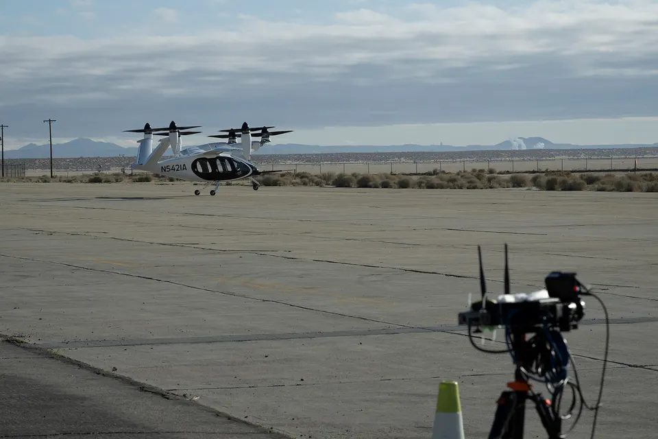 Joby's S4 lifting off at NASA Armstrong: all six propellers point up to hover, then tilt forward so the wing carries it
