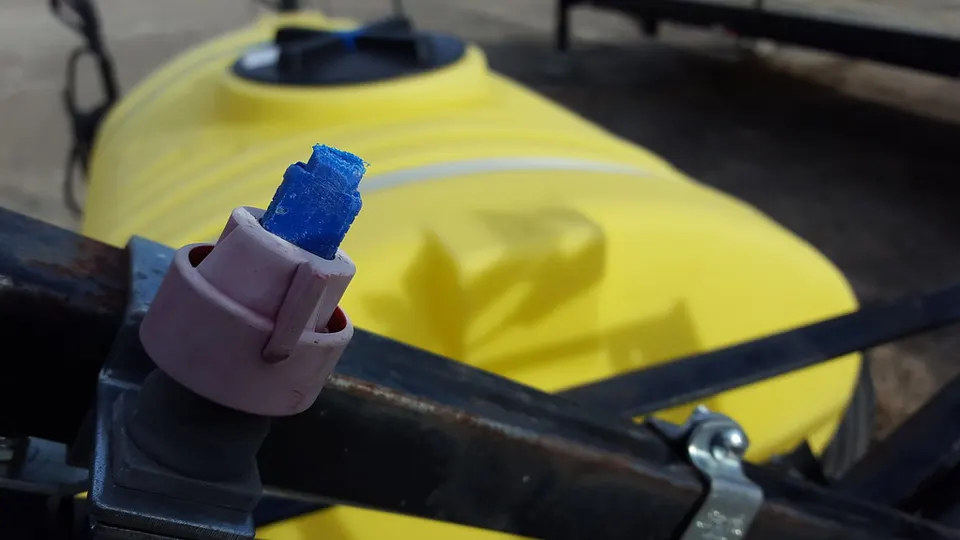 A spray nozzle on a sprayer boom: See & Spray switches nozzles like this on and off one by one when its cameras spot a weed