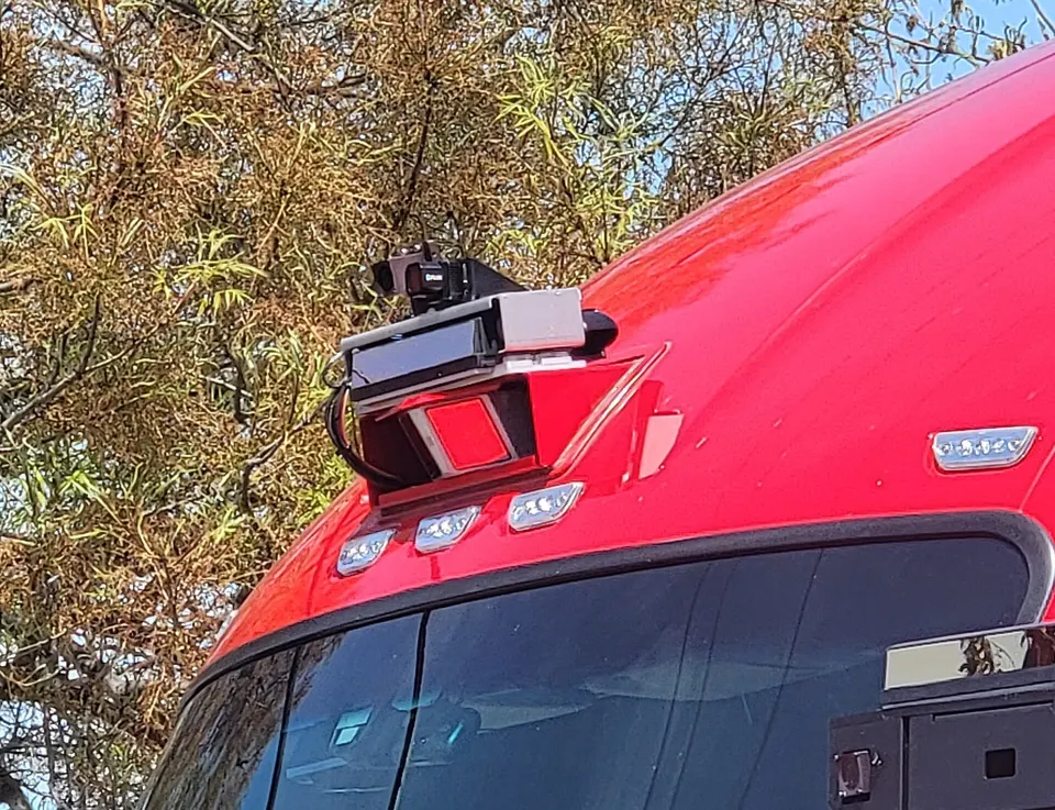 Lidar, radar and cameras on an earlier Kodiak truck's cab roof; newer trucks carry them in pods where the mirrors go