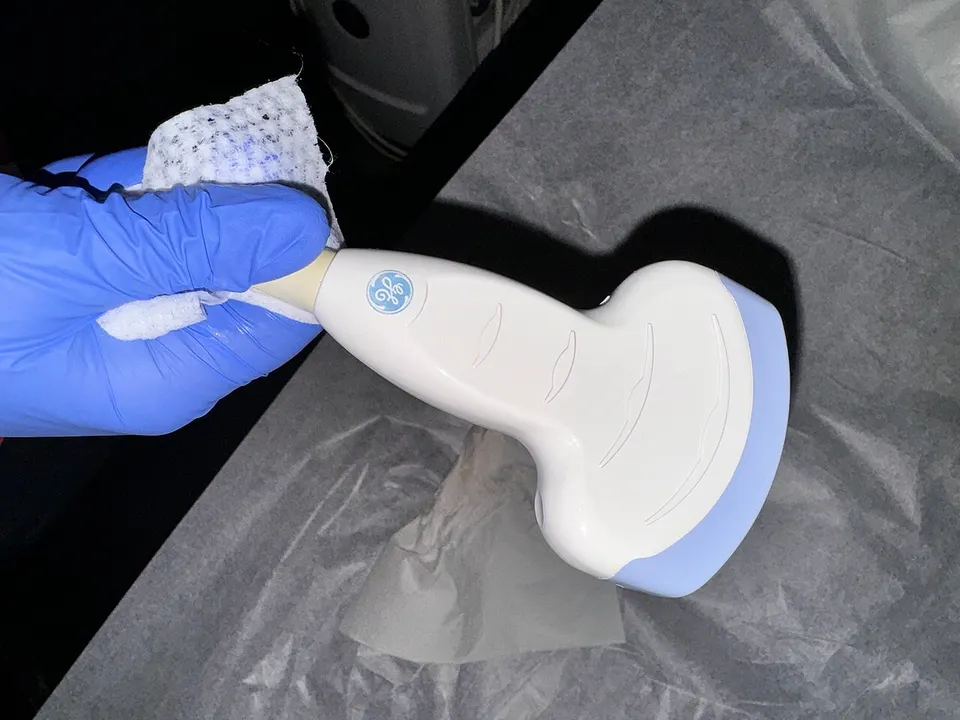 A medical ultrasound probe: rows of tiny transducers send sound into tissue and read the echoes, the tool Merge pairs with sound-sensitive molecules