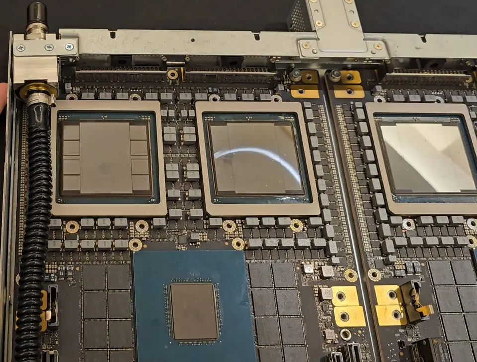 A GB200 tray with the lids off: each Blackwell package holds two big dies ringed by eight HBM3e stacks, beside a Grace CPU