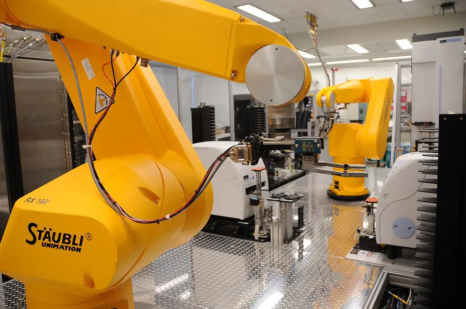 Robot arms moving sample plates between instruments at an NIH lab: the kind of automation Periodic uses to make and test materials the AI proposes