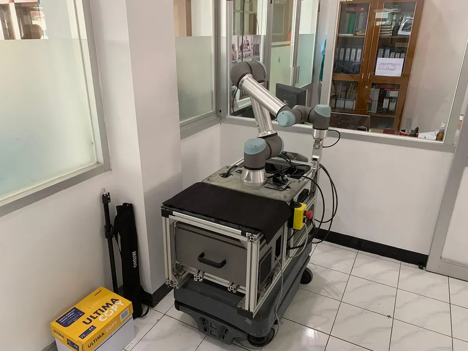 A lab robot arm on a wheeled base, not Physical Intelligence's: π models turn camera images and a spoken task into motions for robots like this