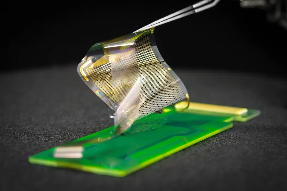 A UC San Diego thin-film brain-surface grid with over 1,000 sensors: the same kind of bendy electrode film as Layer 7, not Precision's own