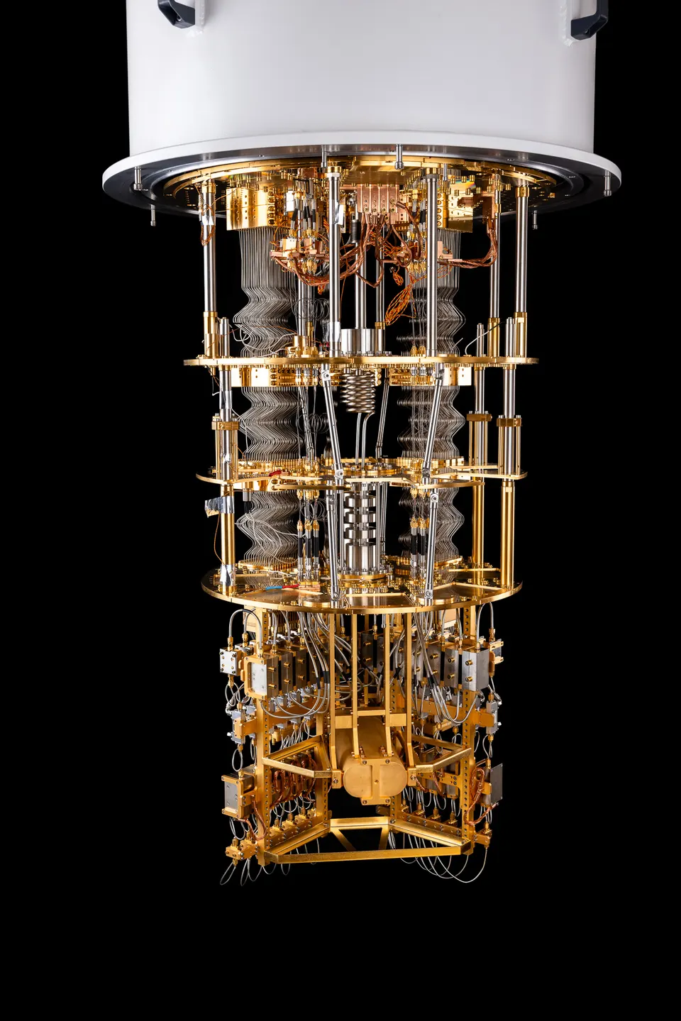 Inside the Ankaa-3 system's cryostat: control lines run down gold stages, each colder than the last, to the superconducting chip at the bottom