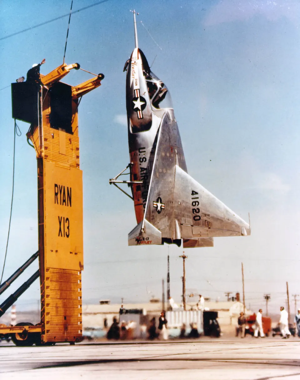 Not X-BAT: the 1950s Ryan X-13 Vertijet hovering on its jet, nose up, beside its launch trailer; X-BAT revives this tail-sitting jet idea