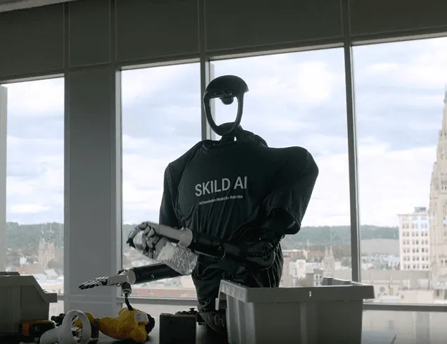 One of the many robot bodies Skild Brain drives: a pair of arms placing dishes in a rack, using the same model as its legged robots