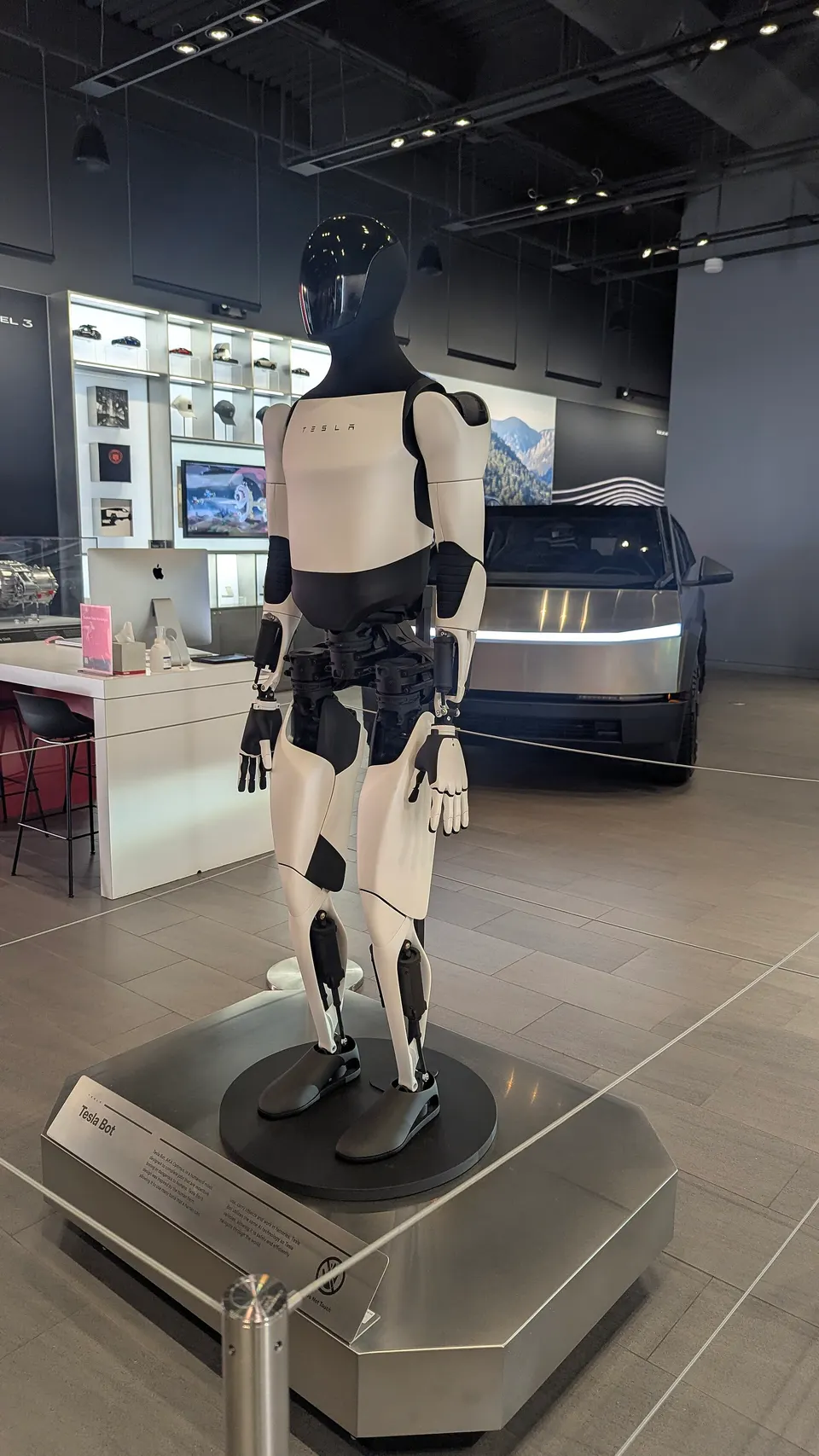 Optimus from the side: electric actuators at every joint and a pair of many-jointed hands