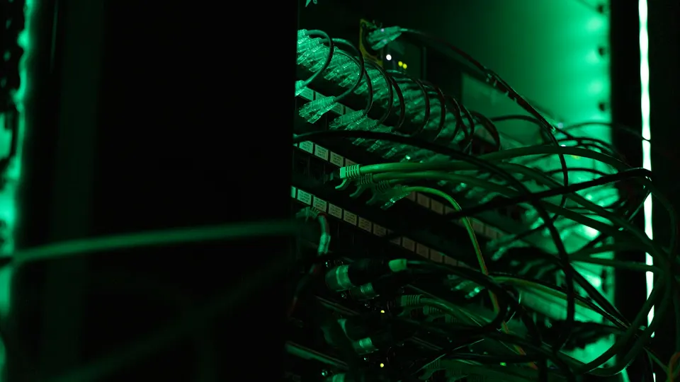 Cabled servers in a rack: Tinker runs your fine-tuning loop on its own GPU clusters, so you never manage machines like these