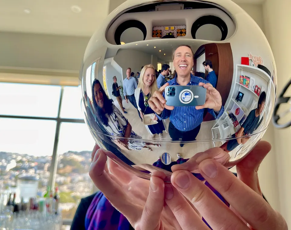 A World Orb held in hand: the mirrored sphere hides the cameras that image the iris, seen here from above