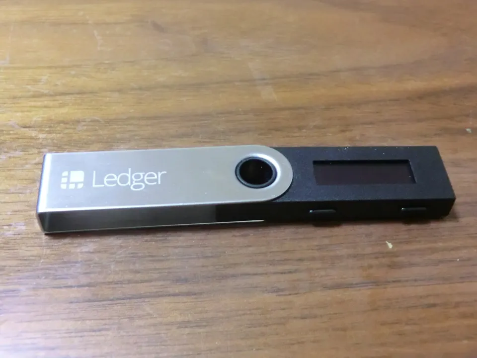 A Ledger hardware wallet: a Uniswap trade is signed with the trader's own key, then the pool contract on Ethereum settles it