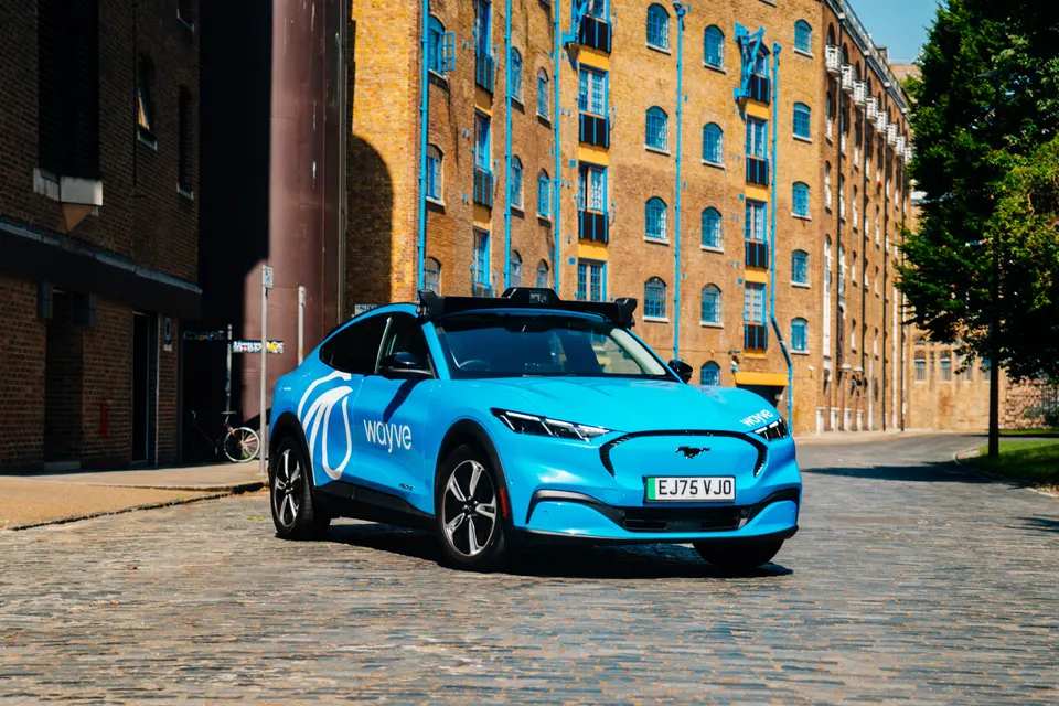 A Wayve test car in London: the slim roof rack holds the cameras whose images one neural network turns into driving
