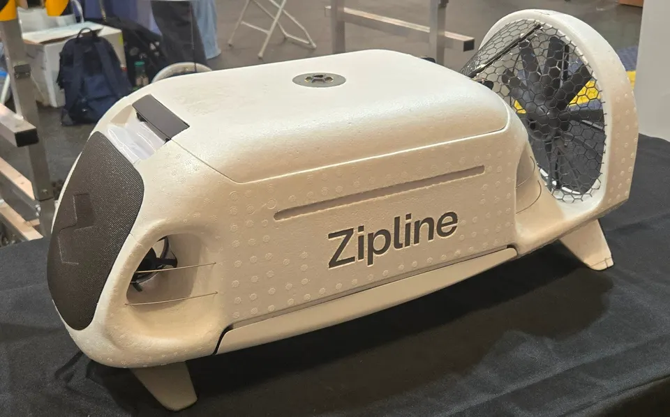 The P2 delivery droid: the pod that the hovering drone lowers on a tether, steering itself down with small fans onto a doorstep